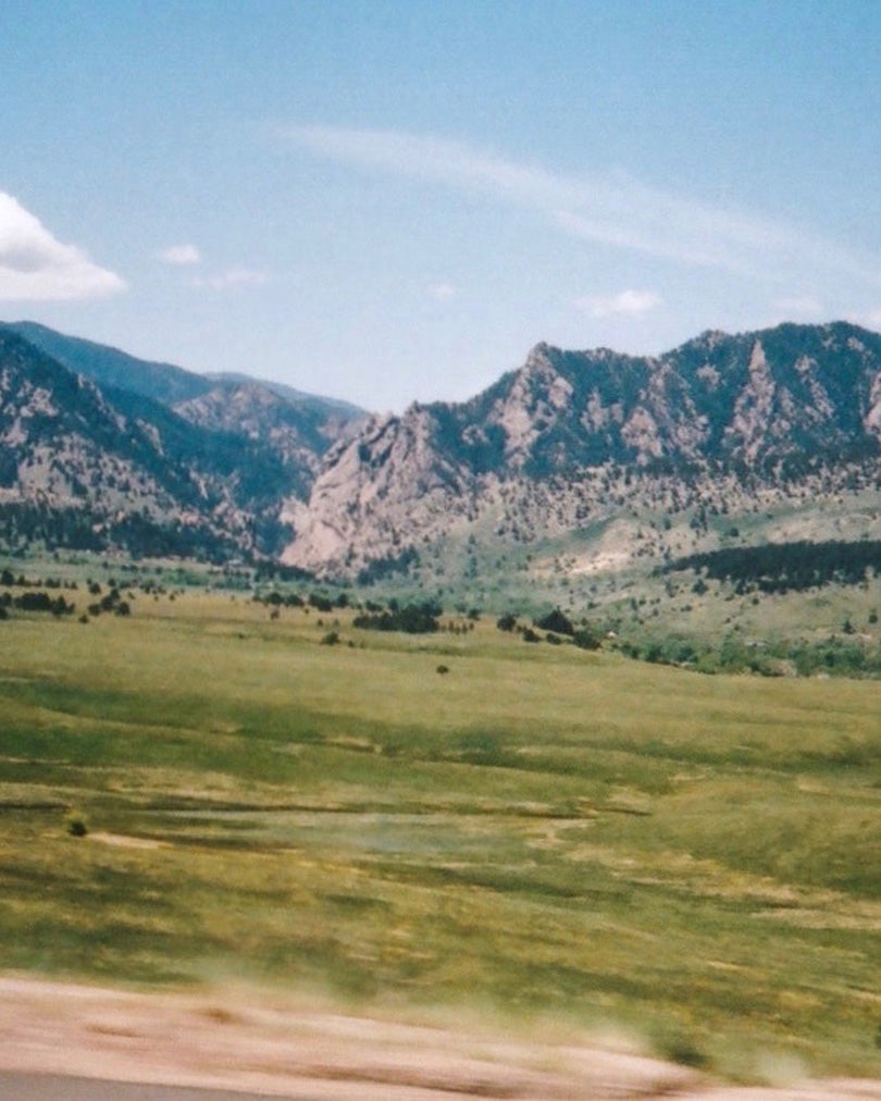 A grainy film photograph depicting the Boulder flatirons.