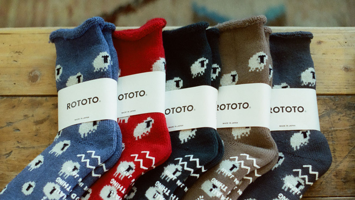 row of patterned socks on a wooden table